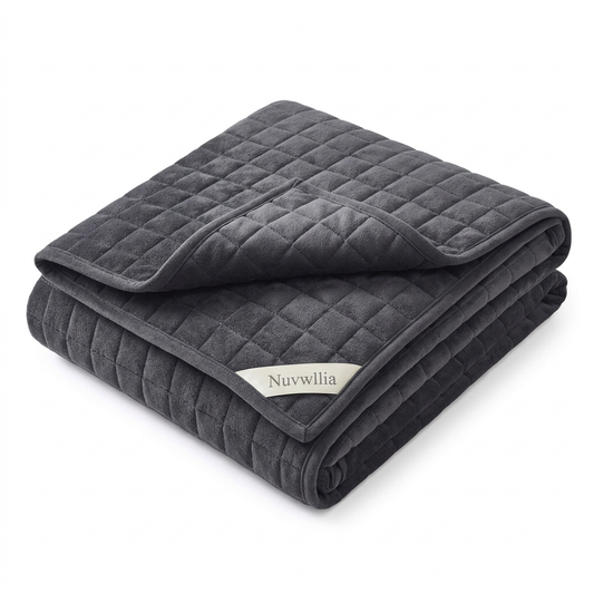 One folded charcoal gray Nuvwllia quilted weighted blanket on a white background